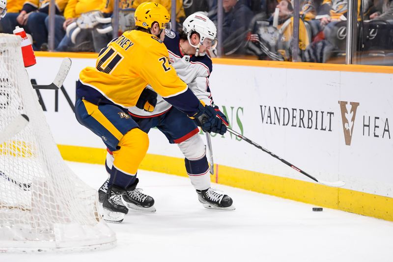 Apr 13, 2024; Nashville, Tennessee, USA; Nashville Predators defenseman Spencer Stastney (24) pokes the puck from Columbus Blue Jackets left wing Dmitri Voronkov (10) during the second period at Bridgestone Arena. Mandatory Credit: Steve Roberts-USA TODAY Sports