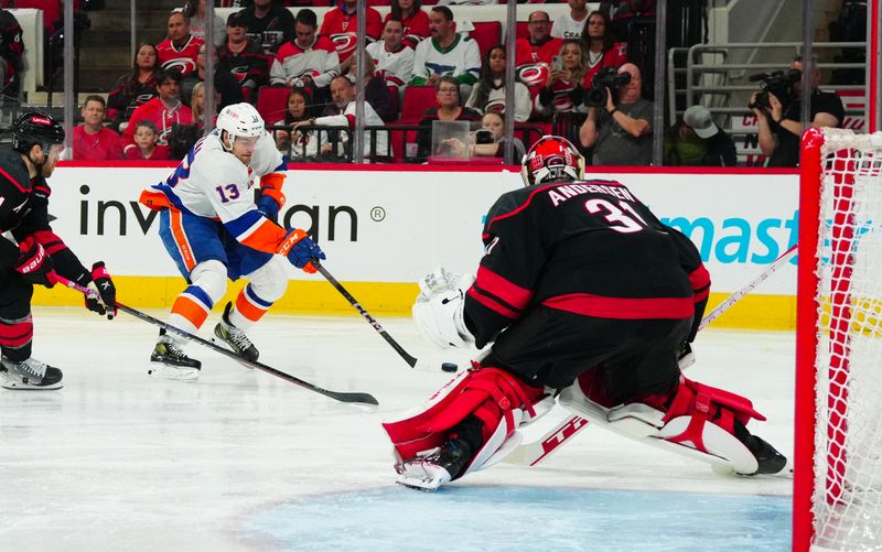 Apr 30, 2024; Raleigh, North Carolina, USA; New York Islanders center Mathew Barzal (13) gets the shot on Carolina Hurricanes goaltender Frederik Andersen (31) during the second period in game five of the first round of the 2024 Stanley Cup Playoffs at PNC Arena. Mandatory Credit: James Guillory-USA TODAY Sports