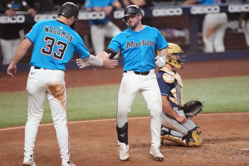 May 18, 2025; Miami, Florida, USA;  Miami Marlins catcher Liam Hicks, right, is congratulated by left fielder Eric Wagaman (33) after his two-run home run in the sixth inning against the Tampa Bay Rays at loanDepot Park. Mandatory Credit: Jim Rassol-Imagn Images