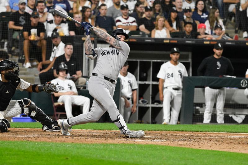 Aug 14, 2024; Chicago, Illinois, USA;  New York Yankees outfielder Alex Verdugo (24) hits a sacrifice fly RBI against the Chicago White Sox during the seventh inning at Guaranteed Rate Field. Mandatory Credit: Matt Marton-USA TODAY Sports