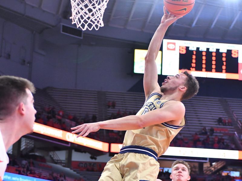 Feb 28, 2023; Syracuse, New York, USA; Georgia Tech Yellow Jackets guard Lance Terry (0) shoots the ball near the basket as Syracuse Orange guard Justin Taylor (5) defends in the first half at the JMA Wireless Dome. Mandatory Credit: Mark Konezny-USA TODAY Sports