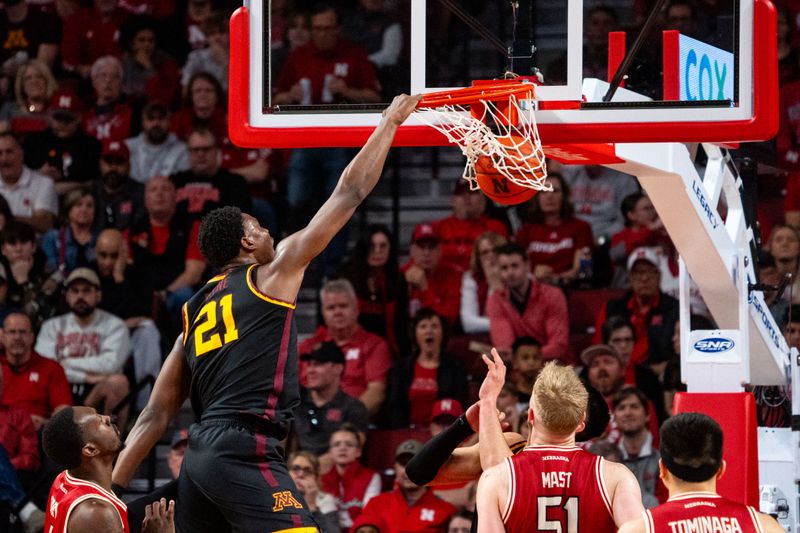 Feb 25, 2024; Lincoln, Nebraska, USA; Minnesota Golden Gophers forward Pharrel Payne (21) dunks the ball against Nebraska Cornhuskers forward Juwan Gary (4), forward Rienk Mast (51) and guard Keisei Tominaga (30) during the first half at Pinnacle Bank Arena. Mandatory Credit: Dylan Widger-USA TODAY Sports