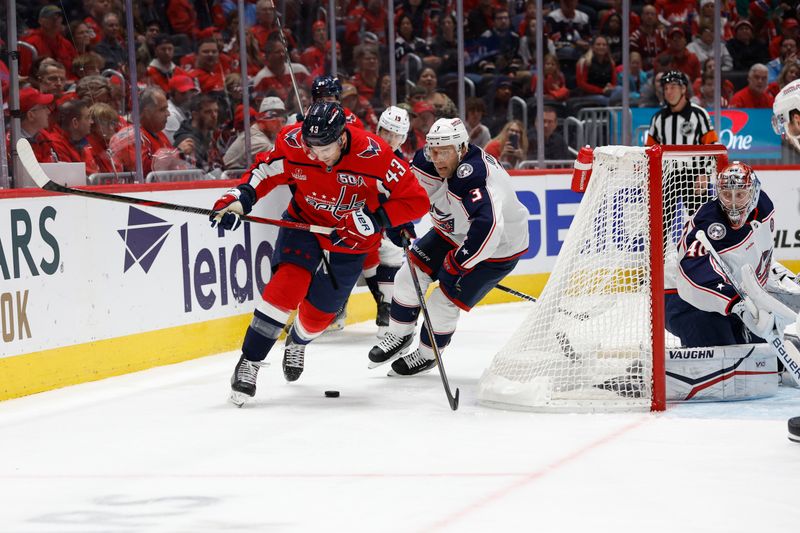 Nov 2, 2024; Washington, District of Columbia, USA; Washington Capitals right wing Tom Wilson (43) attempts to control the puck as Columbus Blue Jackets defenseman Jack Johnson (3) chases in the third period at Capital One Arena. Mandatory Credit: Geoff Burke-Imagn Images