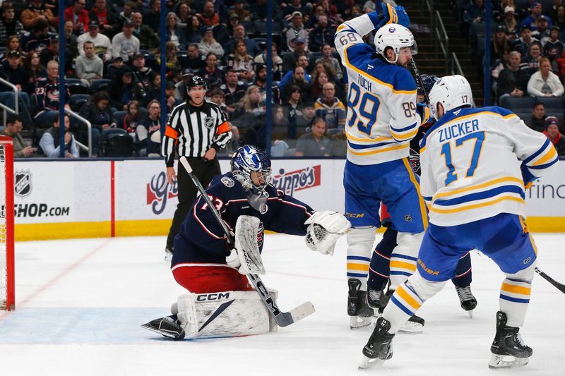 Apr 10, 2025; Columbus, Ohio, USA; Columbus Blue Jackets goalie Jet Greaves (73) makes a glove save as Buffalo Sabres left wing Jason Zucker (17) looks for a rebound during the third period at Nationwide Arena. Mandatory Credit: Russell LaBounty-Imagn Images