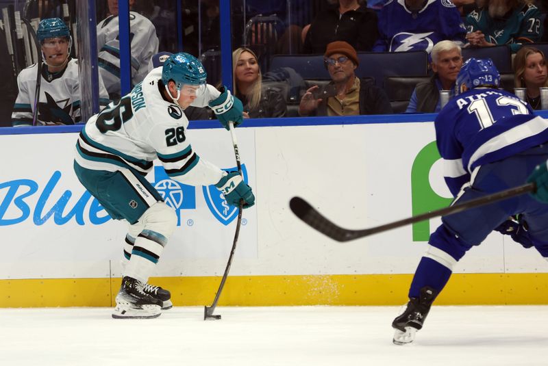 Dec 5, 2024; Tampa, Florida, USA; San Jose Sharks defenseman Jack Thompson (26) skates with the puck against the Tampa Bay Lightning during the second period at Amalie Arena. Mandatory Credit: Kim Klement Neitzel-Imagn Images