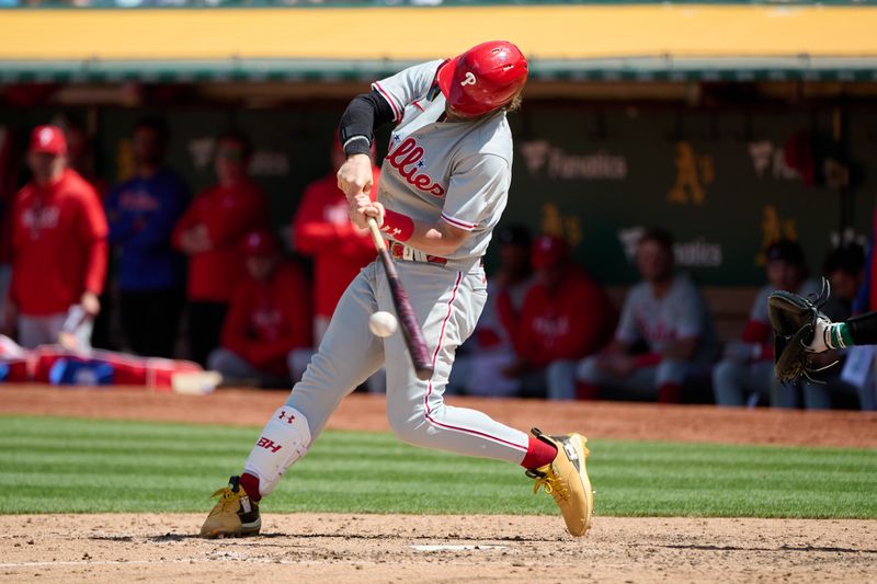 Jun 17, 2023; Oakland, California, USA; Philadelphia Phillies designated hitter Bryce Harper (3) hits a single against the Oakland Athletics during the eighth inning at Oakland-Alameda County Coliseum. Mandatory Credit: Robert Edwards-USA TODAY Sports