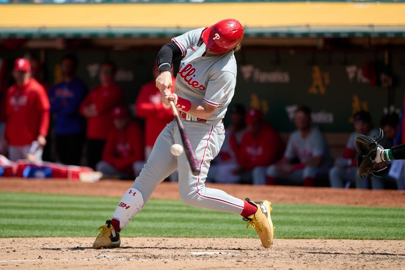 Jun 17, 2023; Oakland, California, USA; Philadelphia Phillies designated hitter Bryce Harper (3) hits a single against the Oakland Athletics during the eighth inning at Oakland-Alameda County Coliseum. Mandatory Credit: Robert Edwards-USA TODAY Sports