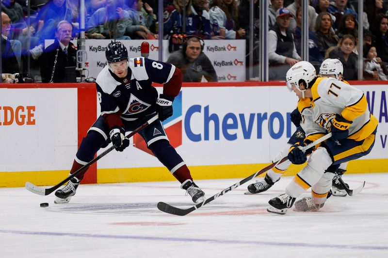 Dec 14, 2024; Denver, Colorado, USA; Colorado Avalanche defenseman Cale Makar (8) controls the puck as Nashville Predators right wing Luke Evangelista (77) and center Tommy Novak (82) defend in the first period at Ball Arena. Mandatory Credit: Isaiah J. Downing-Imagn Images