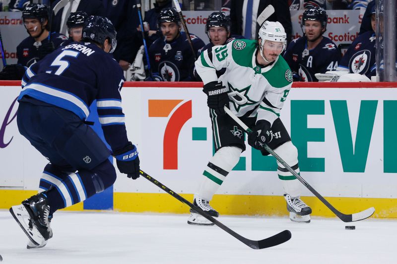 Oct 9, 2025; Winnipeg, Manitoba, CAN; Winnipeg Jets defenseman Luke Schenn (5) gets set to block a shot by Dallas Stars center Matt Duchene (95) in the first period at Canada Life Centre. Mandatory Credit: James Carey Lauder-Imagn Images