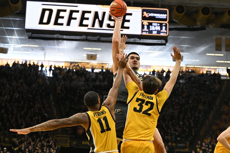 Jan 20, 2024; Iowa City, Iowa, USA; Purdue Boilermakers center Zach Edey (15) shoots the ball over Iowa Hawkeyes forward Owen Freeman (32) and guard Tony Perkins (11) during the first half at Carver-Hawkeye Arena. Mandatory Credit: Jeffrey Becker-USA TODAY Sports