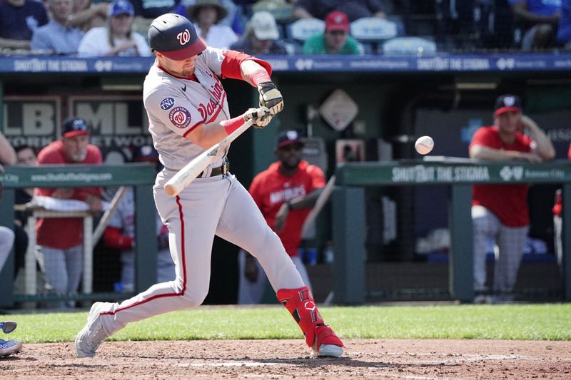 May 27, 2023; Kansas City, Missouri, USA; Washington Nationals right fielder Lane Thomas (28) hits a double against the Kansas City Royals in the fifth inning at Kauffman Stadium. Mandatory Credit: Denny Medley-USA TODAY Sports