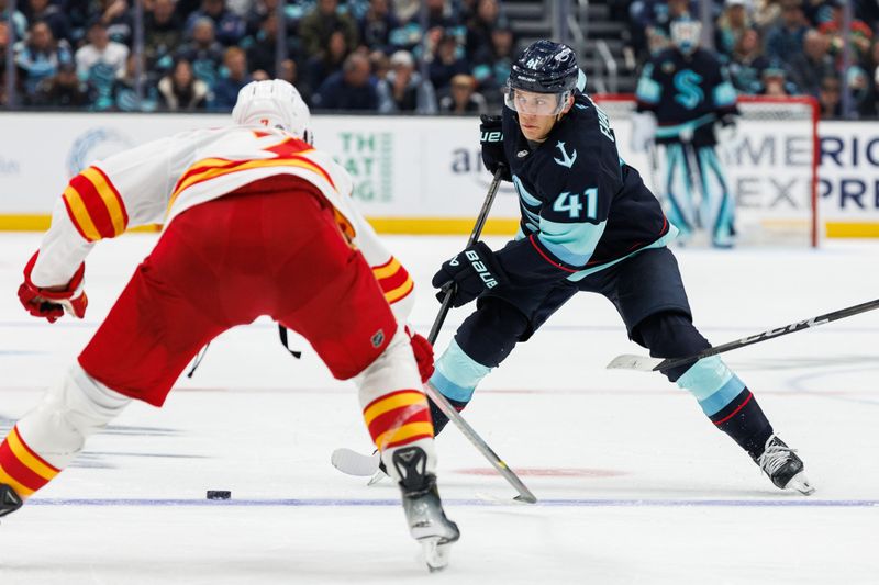 Oct 19, 2024; Seattle, Washington, USA; Seattle Kraken defenseman Ryker Evans (41) moves the puck against the Calgary Flames during the third period at Climate Pledge Arena. Mandatory Credit: Caean Couto-Imagn Images