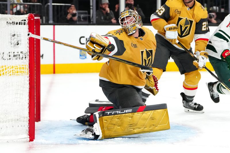 Feb 12, 2024; Las Vegas, Nevada, USA; Vegas Golden Knights goaltender Adin Hill (33) makes a save against the Minnesota Wild during the second period at T-Mobile Arena. Mandatory Credit: Stephen R. Sylvanie-USA TODAY Sports