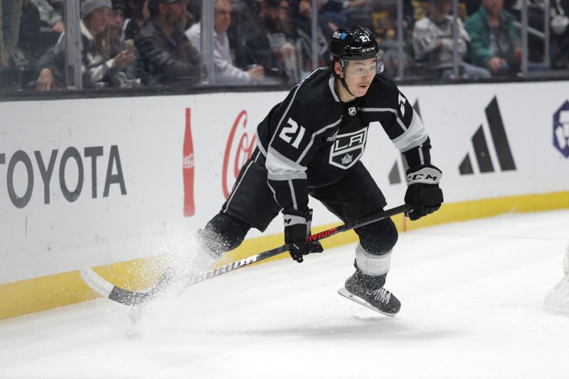 Nov 9, 2023; Los Angeles, California, USA; Los Angeles Kings defensemen Jordan Spence (21) makes a play during the first period against the Pittsburgh Penguins at Crypto.com Arena. Mandatory Credit: Yannick Peterhans-USA TODAY Sports