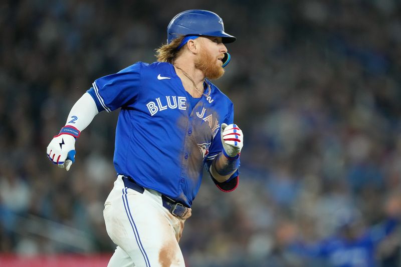 Apr 14, 2024; Toronto, Ontario, CAN; Toronto Blue Jays designated hitter Justin Turner (2) runs to first base on a one run single against the Colorado Rockies during the fifth inning at Rogers Centre. Mandatory Credit: John E. Sokolowski-USA TODAY Sports