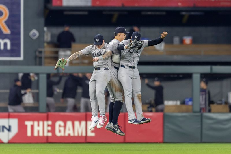 May 14, 2024; Minneapolis, Minnesota, USA; New York Yankees left fielder Alex Verdugo (24), center fielder Aaron Judge (99), and right fielder Juan Soto (22) celebrate after defeating the Minnesota Twins at Target Field. Mandatory Credit: Jesse Johnson-USA TODAY Sports