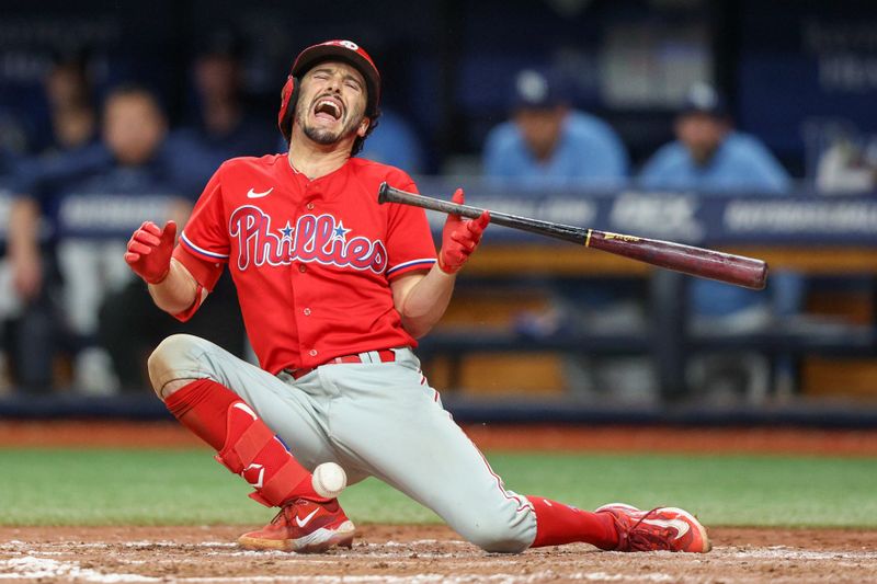 Jul 6, 2023; St. Petersburg, Florida, USA;  Philadelphia Phillies catcher Garrett Stubbs (21) is hit by a pitch against the Tampa Bay Rays in the eleventh inning at Tropicana Field. Mandatory Credit: Nathan Ray Seebeck-USA TODAY Sports