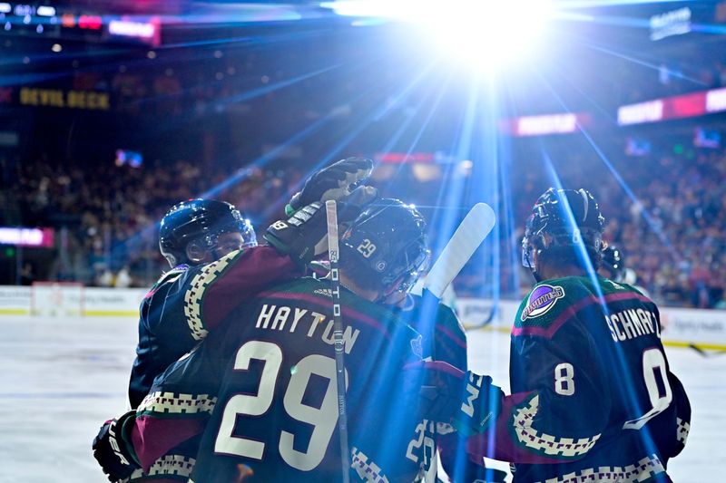 Nov 7, 2023; Tempe, Arizona, USA; Arizona Coyotes right wing Clayton Keller (9) celebrates with center Barrett Hayton (29) and center Nick Schmaltz (8) after scoring a goal in the second period against the Seattle Kraken  at Mullett Arena. Mandatory Credit: Matt Kartozian-USA TODAY Sports