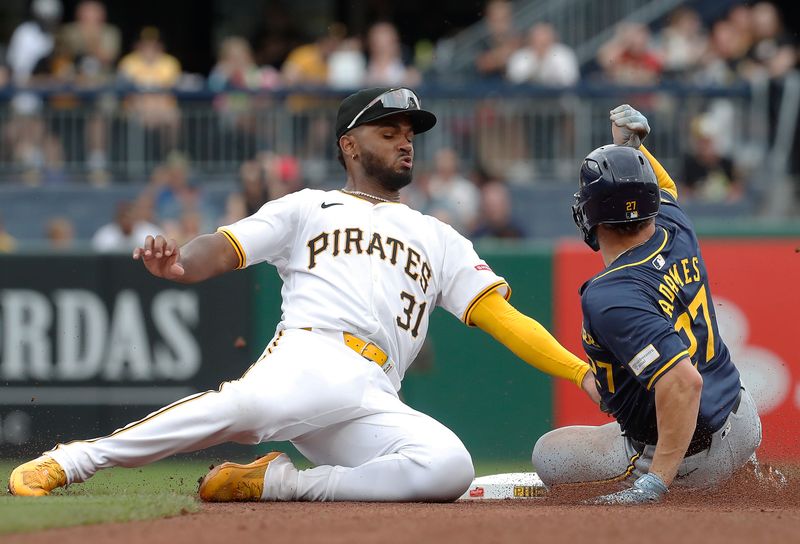 Sep 26, 2024; Pittsburgh, Pennsylvania, USA;  Milwaukee Brewers shortstop Willy Adames (27) steals second base as Pittsburgh Pirates shortstop Liover Peguero (31) takes a wide throw during the fourth inning at PNC Park. Mandatory Credit: Charles LeClaire-Imagn Images