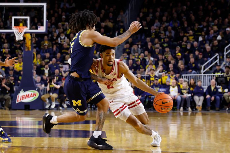 Jan 10, 2026; Ann Arbor, Michigan, USA;  Wisconsin Badgers guard Nick Boyd (2) dribbles defended by Michigan Wolverines guard Elliot Cadeau (3) in the second half at Crisler Center. Mandatory Credit: Rick Osentoski-Imagn Images