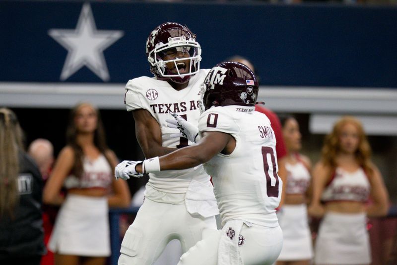 Sep 30, 2023; Arlington, Texas, USA; Texas A&M Aggies wide receiver Evan Stewart (1) and wide receiver Ainias Smith (0) celebrate after Stewart catches a pass for a touchdown against the Arkansas Razorbacks during the first half at AT&T Stadium. Mandatory Credit: Jerome Miron-USA TODAY Sports