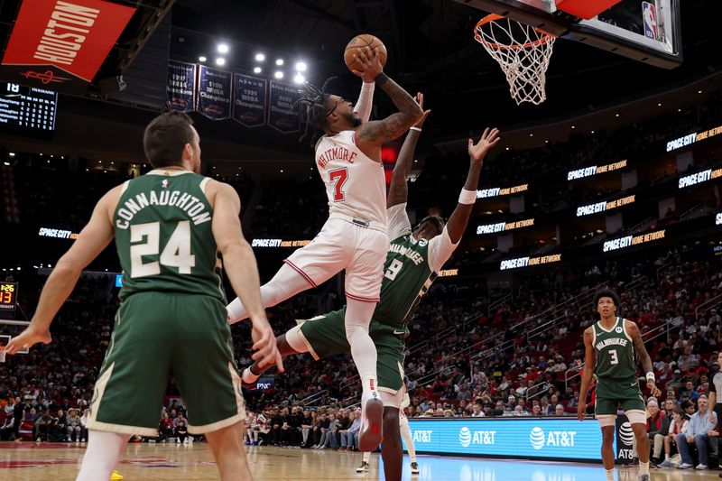 HOUSTON, TEXAS - JANUARY 06: Cam Whitmore #7 of the Houston Rockets shoots the ball while defended by Bobby Portis #9 of the Milwaukee Bucks in the first half at Toyota Center on January 06, 2024 in Houston, Texas.  NOTE TO USER: User expressly acknowledges and agrees that, by downloading and or using this photograph, User is consenting to the terms and conditions of the Getty Images License Agreement. (Photo by Tim Warner/Getty Images)