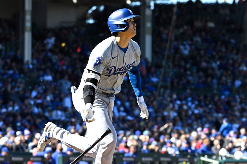 Apr 5, 2024; Chicago, Illinois, USA;  Los Angeles Dodgers two-way player Shohei Ohtani (17) watches his two-run home run against the Chicago Cubs during the fifth inning at Wrigley Field. Mandatory Credit: Matt Marton-USA TODAY Sports