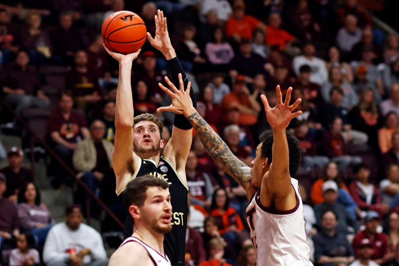 Mar 2, 2024; Blacksburg, Virginia, USA; Wake Forest Demon Deacons forward Andrew Carr (11) shoots the ball against Virginia Tech Hokies center Lynn Kidd (15) during the first half at Cassell Coliseum. Mandatory Credit: Peter Casey-USA TODAY Sports