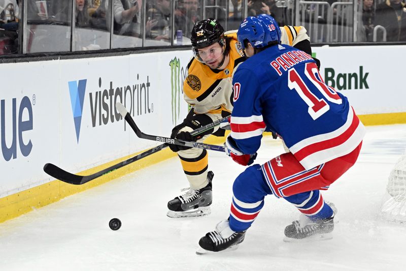 Mar 21, 2024; Boston, Massachusetts, USA; New York Rangers left wing Artemi Panarin (10) and Boston Bruins defenseman Andrew Peeke (52) battle for the puck during the second period at the TD Garden. Mandatory Credit: Brian Fluharty-USA TODAY Sports