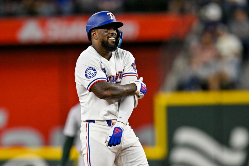 Apr 10, 2024; Arlington, Texas, USA; Texas Rangers right fielder Adolis Garcia (53) celebrates at second base after he hits a double against the Oakland Athletics during the third inning at Globe Life Field. Mandatory Credit: Jerome Miron-USA TODAY Sports