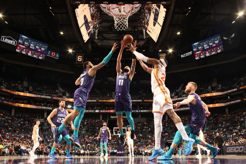 CHARLOTTE, NC - FEBRUARY 14: Miles Bridges #0 and Cody Martin #11 of the Charlotte Hornets rebound the ball during the game Atlanta Hawks on February 14, 2024 at Spectrum Center in Charlotte, North Carolina. NOTE TO USER: User expressly acknowledges and agrees that, by downloading and or using this photograph, User is consenting to the terms and conditions of the Getty Images License Agreement. Mandatory Copyright Notice: Copyright 2024 NBAE (Photo by Kent Smith/NBAE via Getty Images)