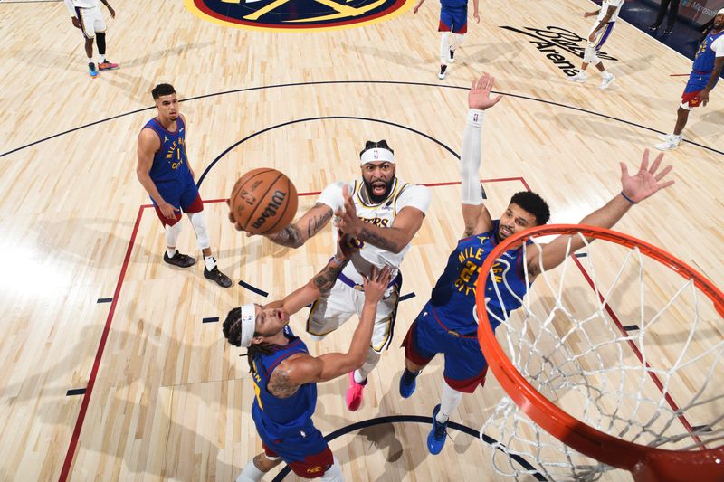 DENVER, CO - APRIL 20: Anthony Davis #3 of the Los Angeles Lakers drives to the basket during the game against the Denver Nuggets during Round 1 Game 1 of the 2024 NBA Playoffs on April 20, 2024 at the Ball Arena in Denver, Colorado. NOTE TO USER: User expressly acknowledges and agrees that, by downloading and/or using this Photograph, user is consenting to the terms and conditions of the Getty Images License Agreement. Mandatory Copyright Notice: Copyright 2024 NBAE (Photo by Garrett Ellwood/NBAE via Getty Images)