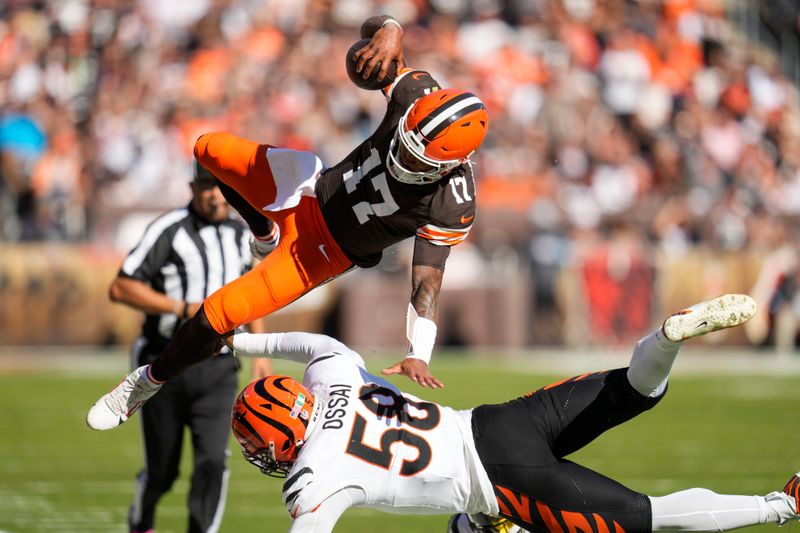 Cleveland Browns quarterback Dorian Thompson-Robinson (17) is tackled by Cincinnati Bengals defensive end Joseph Ossai (58) in the second half of an NFL football game, Sunday, Oct. 20, 2024, in Cleveland. (AP Photo/Sue Ogrocki)