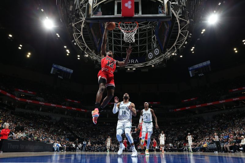 MINNEAPOLIS, MN -  MARCH 31: Ayo Dosunmu #12 of the Chicago Bulls drives to the basket during the game against the Minnesota Timberwolves on March 31, 2024 at Target Center in Minneapolis, Minnesota. NOTE TO USER: User expressly acknowledges and agrees that, by downloading and or using this Photograph, user is consenting to the terms and conditions of the Getty Images License Agreement. Mandatory Copyright Notice: Copyright 2024 NBAE (Photo by David Sherman/NBAE via Getty Images)