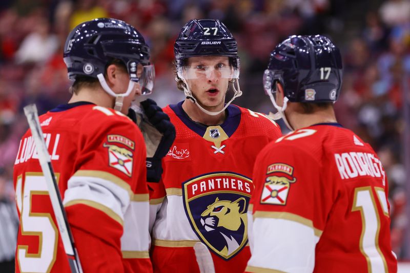 Apr 9, 2024; Sunrise, Florida, USA; Florida Panthers center Eetu Luostarinen (27) talks to center Anton Lundell (15) and center Evan Rodrigues (17) during the first period at Amerant Bank Arena. Mandatory Credit: Sam Navarro-USA TODAY Sports