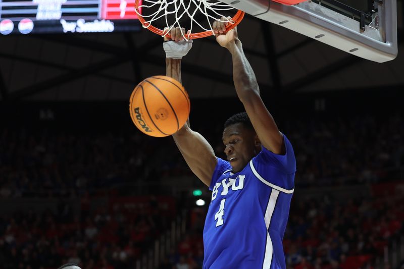 Dec 9, 2023; Salt Lake City, Utah, USA; Brigham Young Cougars forward Atiki Ally Atiki (4) dunks the ball against the Utah Utes during the first half at Jon M. Huntsman Center. Mandatory Credit: Rob Gray-USA TODAY Sports