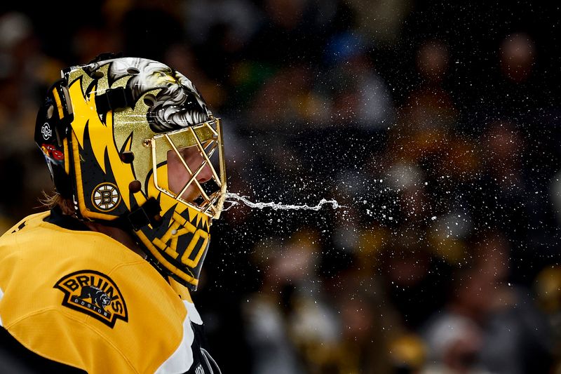 Nov 16, 2024; Boston, Massachusetts, USA; Boston Bruins goaltender Joonas Korpisalo (70) spits out some water during a stop in the play during the second period against the St. Louis Blues at TD Garden. Mandatory Credit: Winslow Townson-Imagn Images