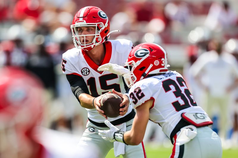 Sep 17, 2022; Columbia, South Carolina, USA; Georgia Bulldogs quarterback Carson Beck (15) hands off to Georgia Bulldogs running back Cash Jones (32) against the South Carolina Gamecocks in the second half at Williams-Brice Stadium. Mandatory Credit: Jeff Blake-USA TODAY Sports