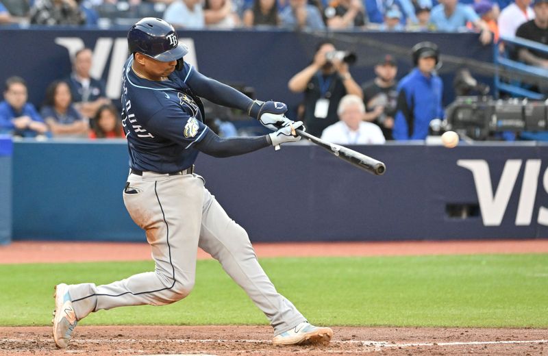 Sep 30, 2023; Toronto, Ontario, CAN;   Tampa Bay Rays catcher Christian Bethancourt (14) hits a double against the Toronto Blue Jays in the eighth inning at Rogers Centre. Mandatory Credit: Dan Hamilton-USA TODAY Sports