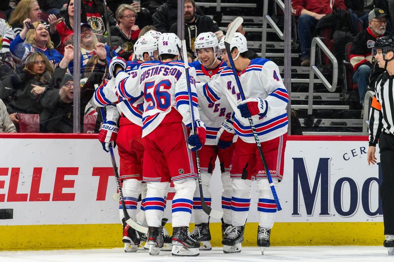 Feb 9, 2024; Chicago, Illinois, USA; New York Rangers center Jonny Brodzinski (22) celebrates his goal with teammates against the Chicago Blackhawks during the second period at the United Center. Mandatory Credit: Daniel Bartel-USA TODAY Sports