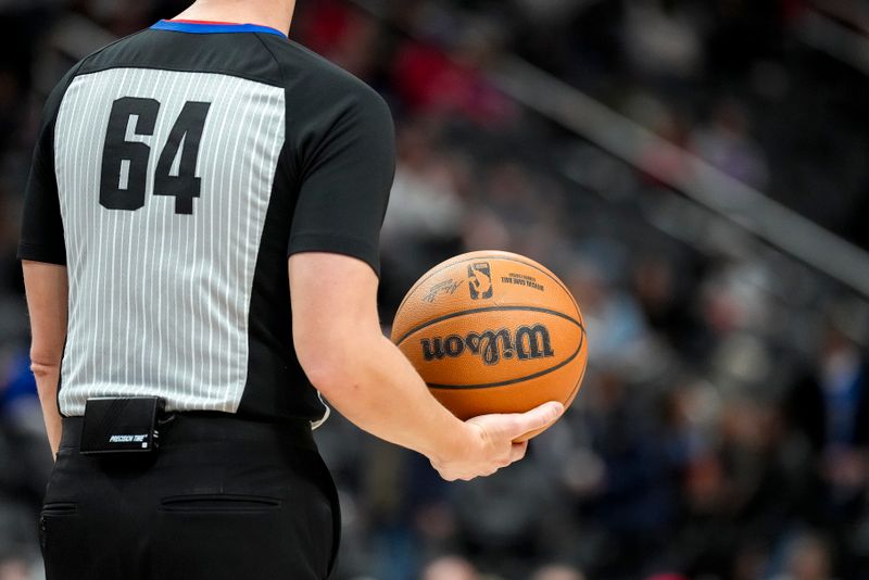 DETROIT, MICHIGAN - JANUARY 17: Referee Justin Van Duyne #64 holds a Wilson brand NBA basketball during the game between the Detroit Pistons and Minnesota Timberwolves at Little Caesars Arena on January 17, 2024 in Detroit, Michigan. NOTE TO USER: User expressly acknowledges and agrees that, by downloading and or using this photograph, User is consenting to the terms and conditions of the Getty Images License Agreement. (Photo by Nic Antaya/Getty Images)