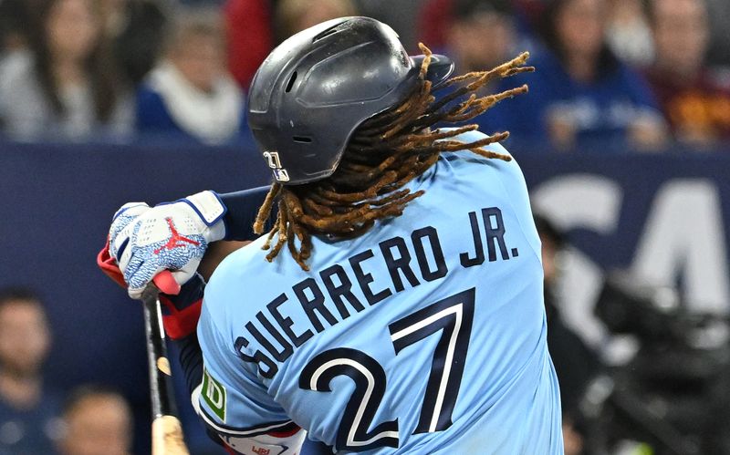 Sep 14, 2023; Toronto, Ontario, CAN;   Toronto Blue Jays first baseman Vladimir Guerrero Jr. (27) takes a swinging strike against the Texas Rangers in the seventh inning at Rogers Centre. Mandatory Credit: Dan Hamilton-USA TODAY Sports