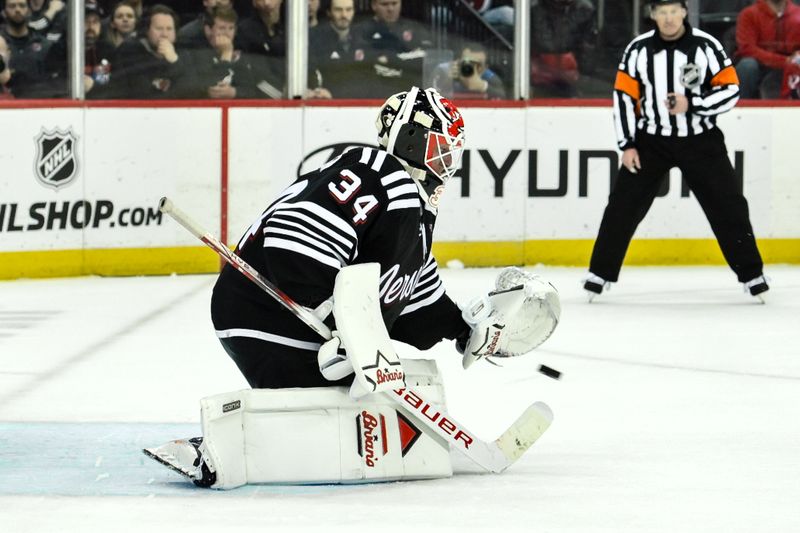 Apr 7, 2024; Newark, New Jersey, USA; New Jersey Devils goaltender Jake Allen (34) makes a save against the Nashville Predators during the overtime shootout at Prudential Center. Mandatory Credit: John Jones-USA TODAY Sports