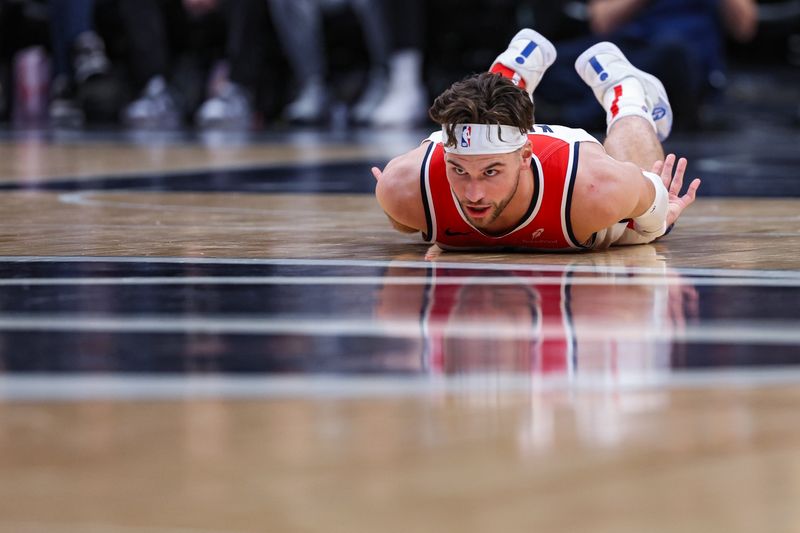 WASHINGTON, DC - MARCH 21: Corey Kispert #24 of the Washington Wizards falls the court against the Sacramento Kings during the first half at Capital One Arena on March 21, 2024 in Washington, DC. NOTE TO USER: User expressly acknowledges and agrees that, by downloading and or using this photograph, User is consenting to the terms and conditions of the Getty Images License Agreement. (Photo by Patrick Smith/Getty Images)