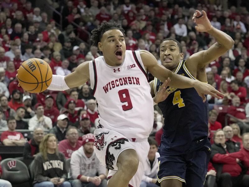 Dec 3, 2024; Madison, Wisconsin, USA; Wisconsin guard John Tonje (9) drives past Michigan guard Nimari Burnett (4) during the second half of their game Tuesday, December 3, 2024 at the Kohl Center in Madison, Wisconsin. Michigan beat Wisconsin 67-64.  Mandatory Credit: Mark Hoffman/USA TODAY Network via Imagn Images 