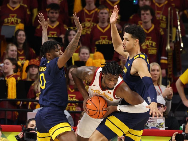 Feb 27, 2023; Ames, Iowa, USA; Iowa State Cyclones forward Tre King (0) is trapped by West Virginia Mountaineers guard Kedrian Johnson (0) and West Virginia Mountaineers forward Emmitt Matthews Jr. (1) during the first half at James H. Hilton Coliseum. Mandatory Credit: Reese Strickland-USA TODAY Sports