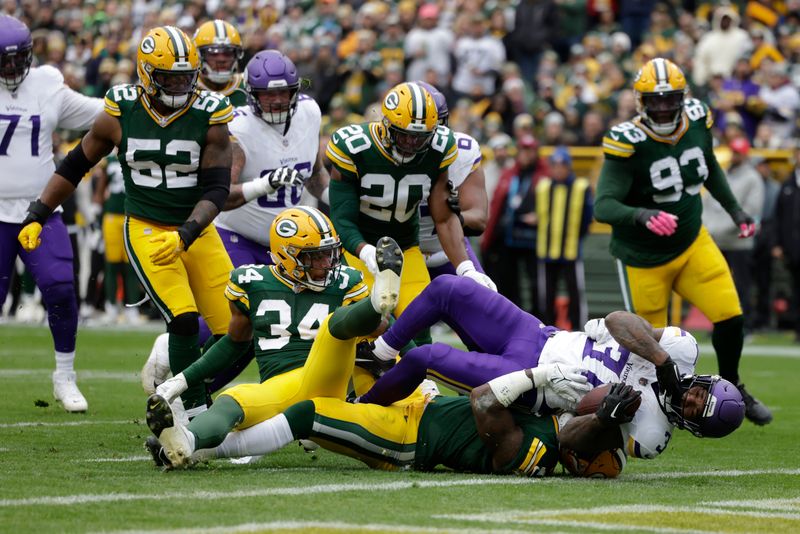 Minnesota Vikings running back Cam Akers (31) scores a 6-yard touchdown during the first half of an NFL football game against the Green Bay Packers, Sunday, Oct. 29, 2023, in Green Bay, Wis. (AP Photo/Matt Ludtke)