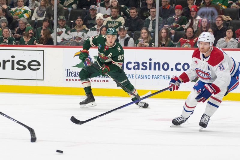 Dec 21, 2023; Saint Paul, Minnesota, USA; Minnesota Wild left wing Kirill Kaprizov (97) picks up the assist on this pass to left wing Matt Boldy (12) who scores against the Montreal Canadiens in the first period at Xcel Energy Center. Mandatory Credit: Matt Blewett-USA TODAY Sports