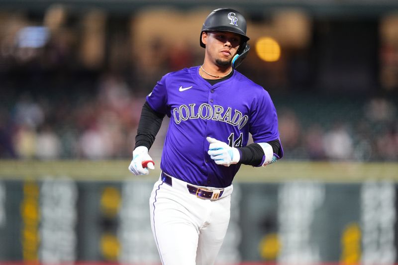 Sep 17, 2024; Denver, Colorado, USA; Colorado Rockies shortstop Ezequiel Tovar (14) runs off a solo home run in the third inning against the Arizona Diamondbacks at Coors Field. Mandatory Credit: Ron Chenoy-Imagn Images