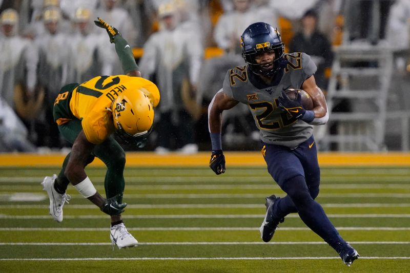 Nov 25, 2023; Waco, Texas, USA; West Virginia Mountaineers running back Jahiem White (22) carries the ball past  Baylor Bears cornerback Chateau Reed (21) during the first half at McLane Stadium. Mandatory Credit: Raymond Carlin III-USA TODAY Sports